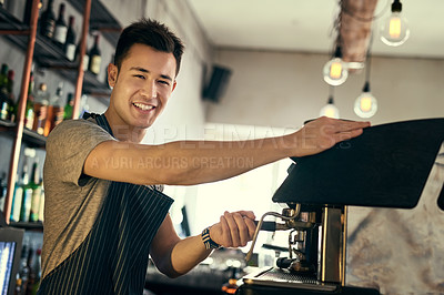 Buy stock photo Cropped portrait of a young barista preparing drinks in his coffee shop