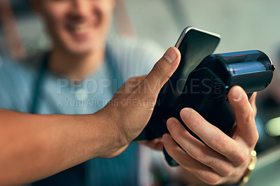 Buy stock photo Cropped shot of an unrecognizable barista taking a NFC payment