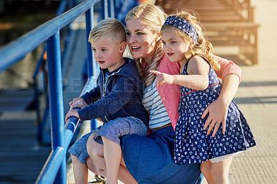 Buy stock photo Shot of a mother enjoying the day outside with her two young children
