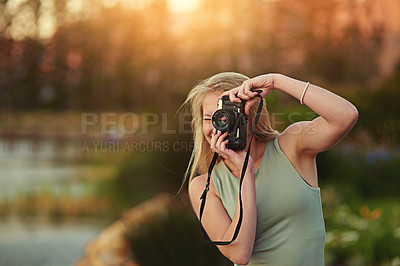 Buy stock photo Portrait of a young woman taking photos on her camera outside