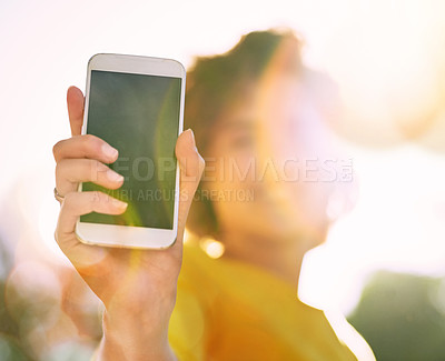 Buy stock photo Cropped shot of an unrecognizable young woman using showing you a smartphone