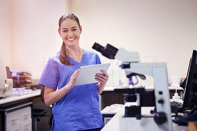 Buy stock photo Portrait of a young scientist using a digital tablet while working in a laboratory