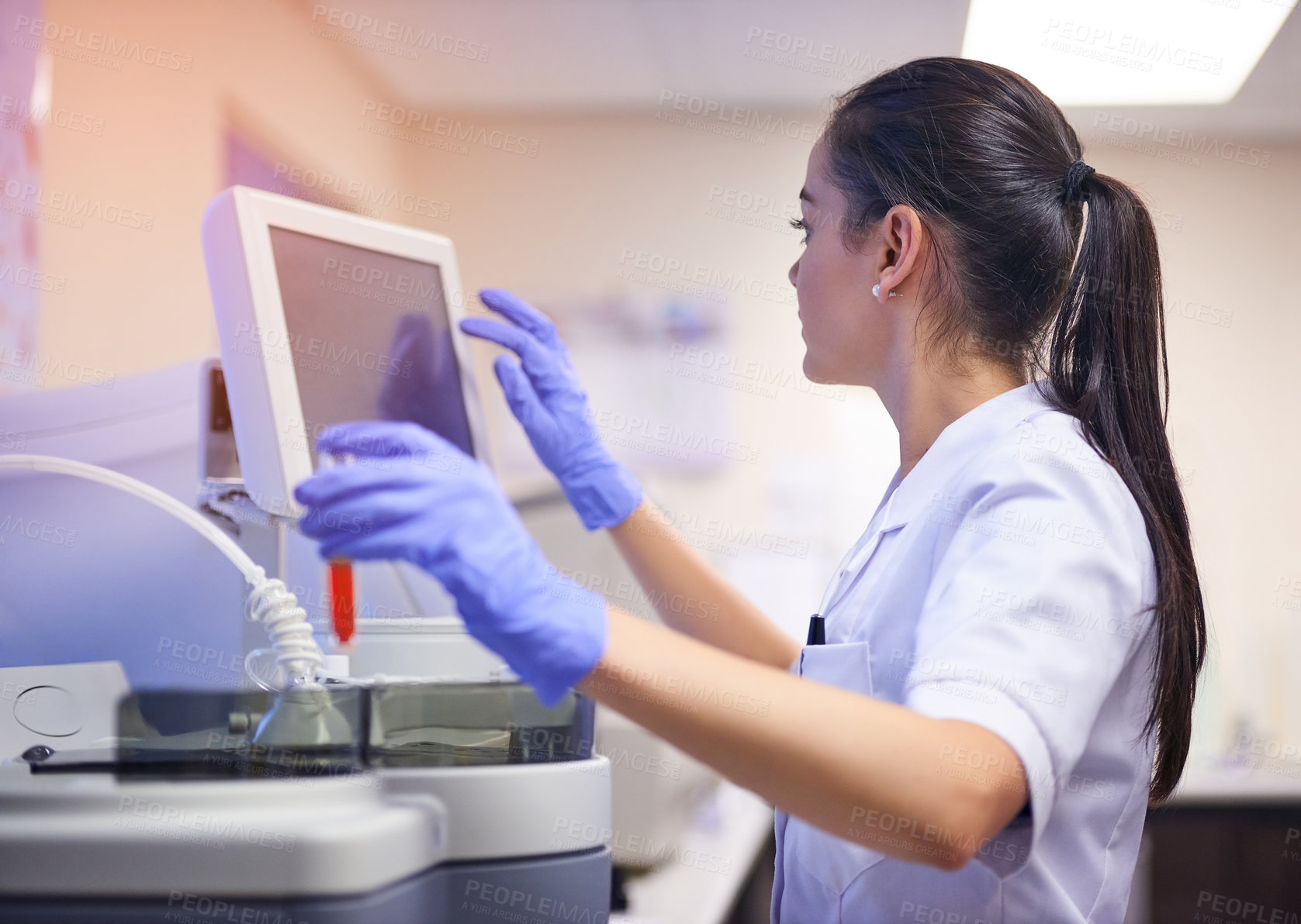 Buy stock photo Shot of a young scientist using a computer to conduct a medical test in a laboratory