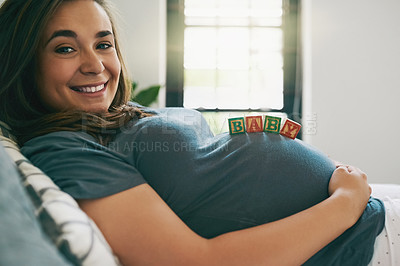 Buy stock photo Shot of a young woman with baby blocks on her pregnant belly