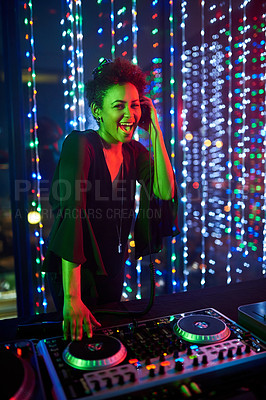 Buy stock photo Portrait of an attractive young female dj playing in a nightclub