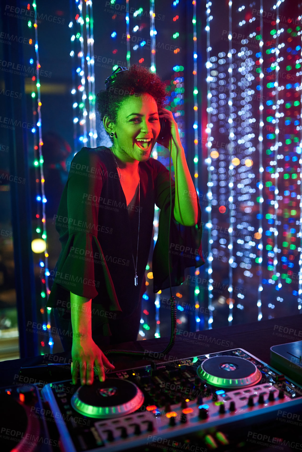 Buy stock photo Portrait of an attractive young female dj playing in a nightclub