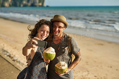 Buy stock photo Smile, couple and selfie for picture on beach for social media update, photography and coconut drink for memory. Happy, man and woman travel to tropical ocean together for summer vacation in Spain