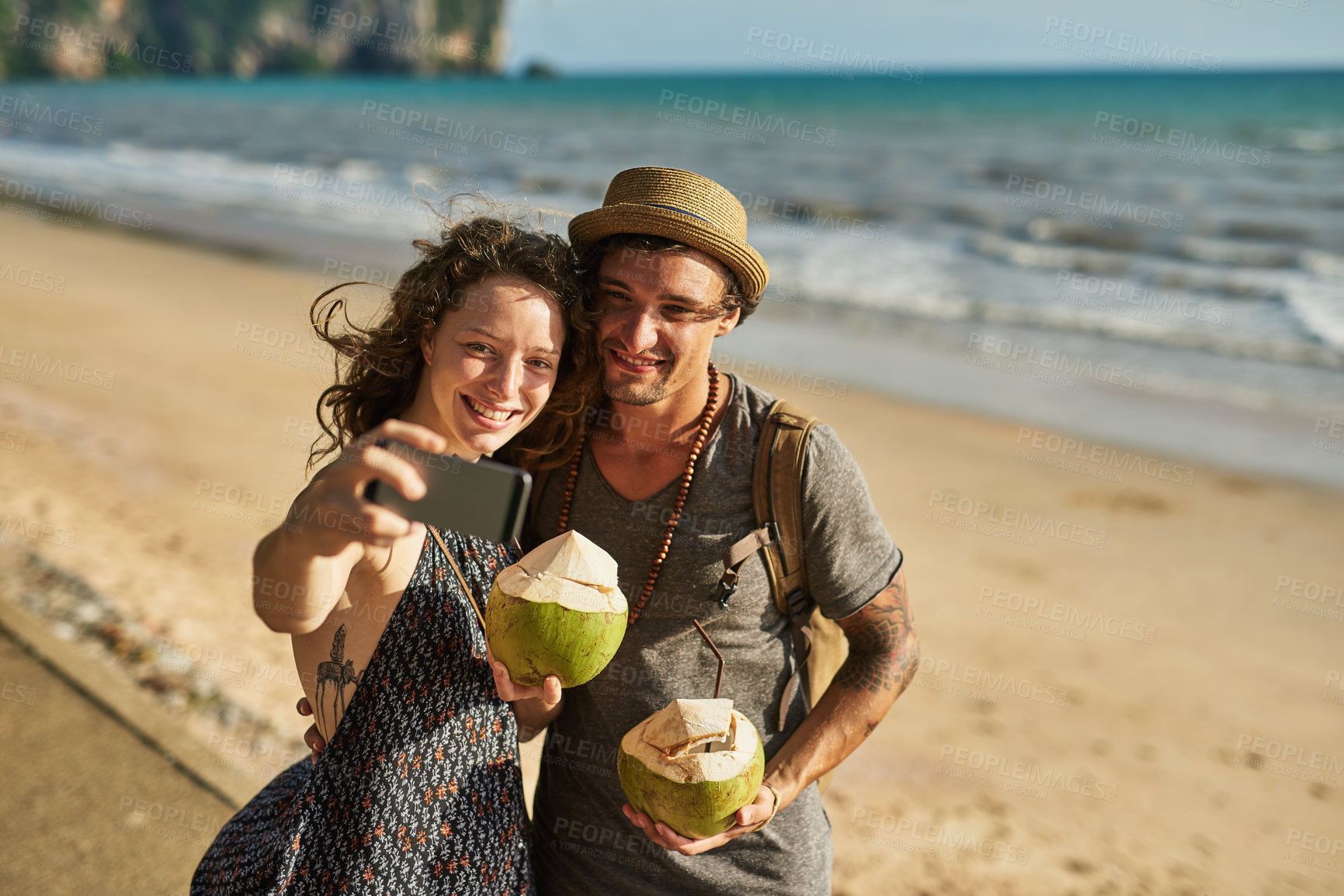 Buy stock photo Smile, couple and selfie for picture on beach for social media update, photography and coconut drink for memory. Happy, man and woman travel to tropical ocean together for summer vacation in Spain