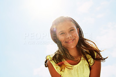 Buy stock photo Portrait of a happy girl standing outside on a bright summer’s day