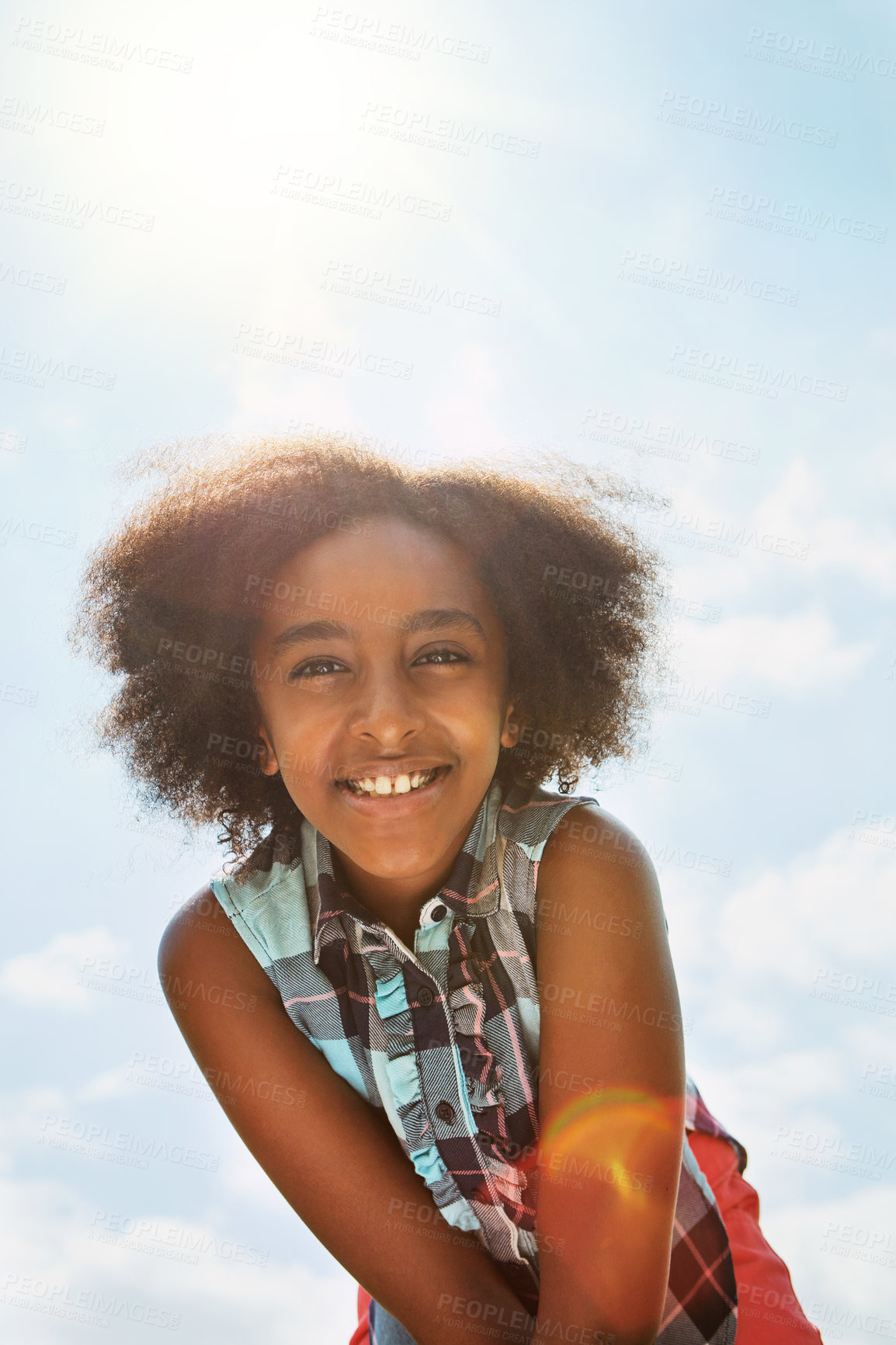 Buy stock photo Portrait of a happy girl standing outside on a bright summer’s day