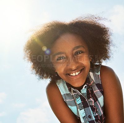 Buy stock photo Portrait of a happy girl standing outside on a bright summer’s day