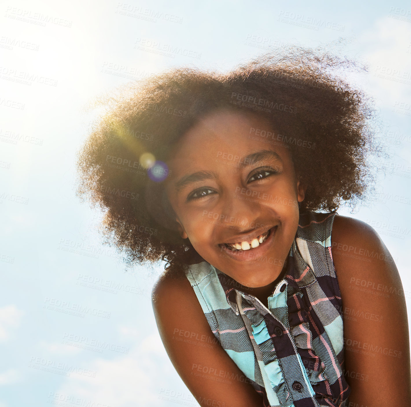 Buy stock photo Portrait of a happy girl standing outside on a bright summer’s day