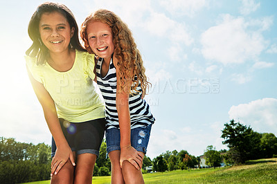 Buy stock photo Portrait of two happy young friends hanging out together on a bright day outside