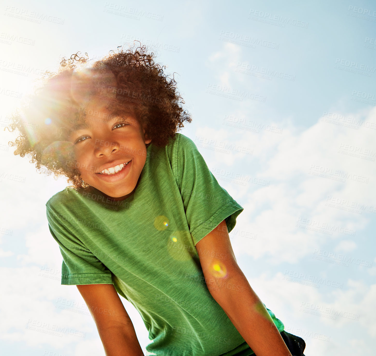 Buy stock photo Portrait, outdoor and boy with sunshine, child and clouds with happiness, weekend break and summer. Face, person and kid with fun, nature and cheerful with joy, excited and blue sky with lens flare