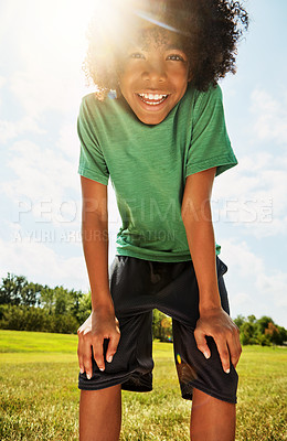 Buy stock photo Portrait of a happy boy standing outside on a bright summer’s day