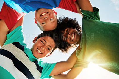 Buy stock photo Blue sky, low angle and happy portrait of kids for friendship, playing and fun together. Diversity, youth and boys huddle in circle for childhood, game and camp for school, recess and playground