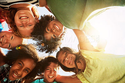 Buy stock photo Happy, huddle and portrait of kids in park for bonding, playing and fun together outdoors. Diversity, youth and low angle of children hug in circle for childhood, friendship and relax on weekend