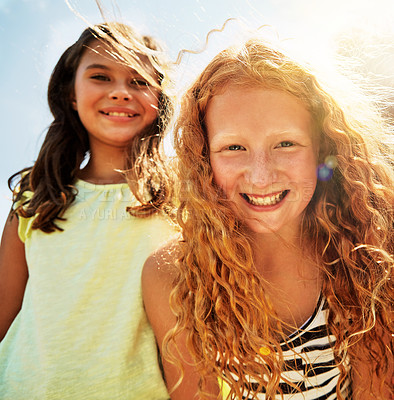 Buy stock photo Portrait of two happy young friends hanging out together on a bright day outside