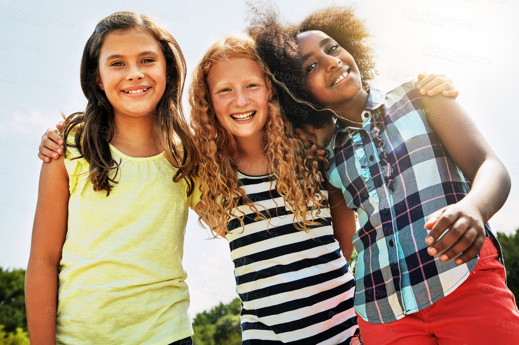 Buy stock photo Portrait of a group of diverse and happy kids hanging out together on a bright day outside