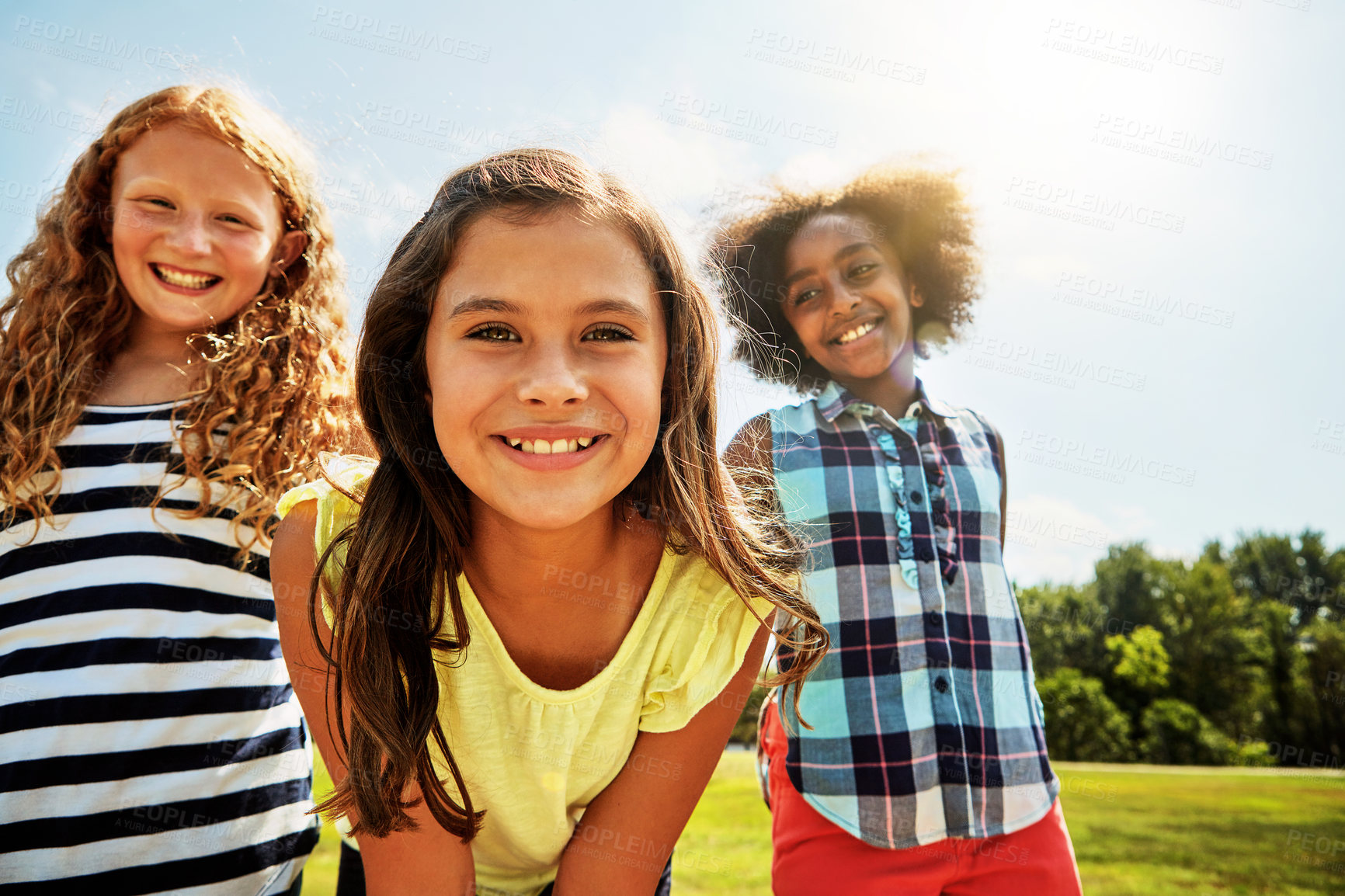 Buy stock photo Portrait of a group of diverse and happy kids hanging out together on a bright day outside