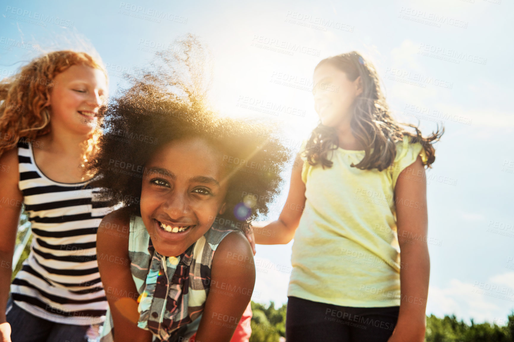 Buy stock photo Portrait of a group of diverse and happy kids hanging out together on a bright day outside