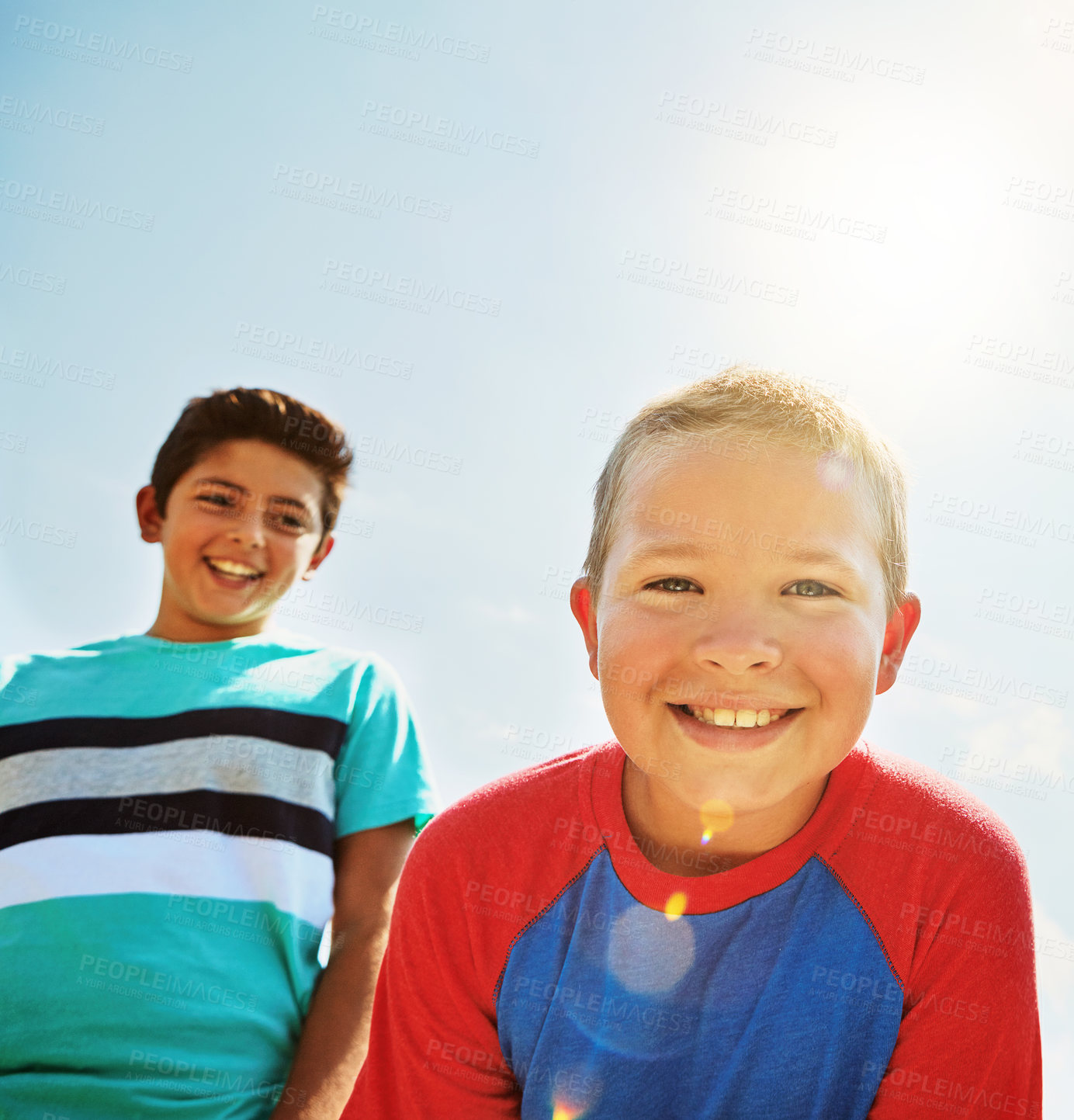 Buy stock photo Portrait of two happy young friends hanging out together on a bright day outside