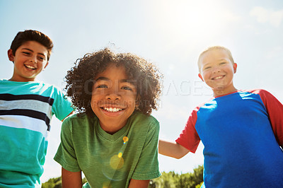 Buy stock photo Portrait of a group of diverse and happy kids hanging out together on a bright day outside