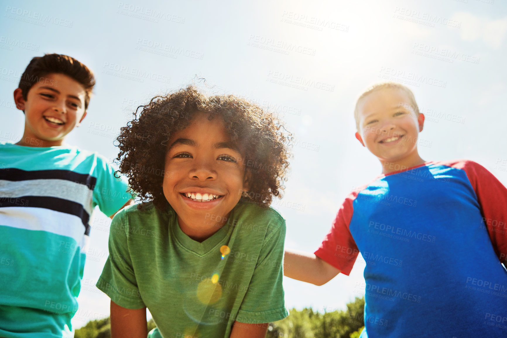 Buy stock photo Portrait of a group of diverse and happy kids hanging out together on a bright day outside