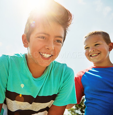 Buy stock photo Shot of two happy young friends hanging out together on a bright day outside