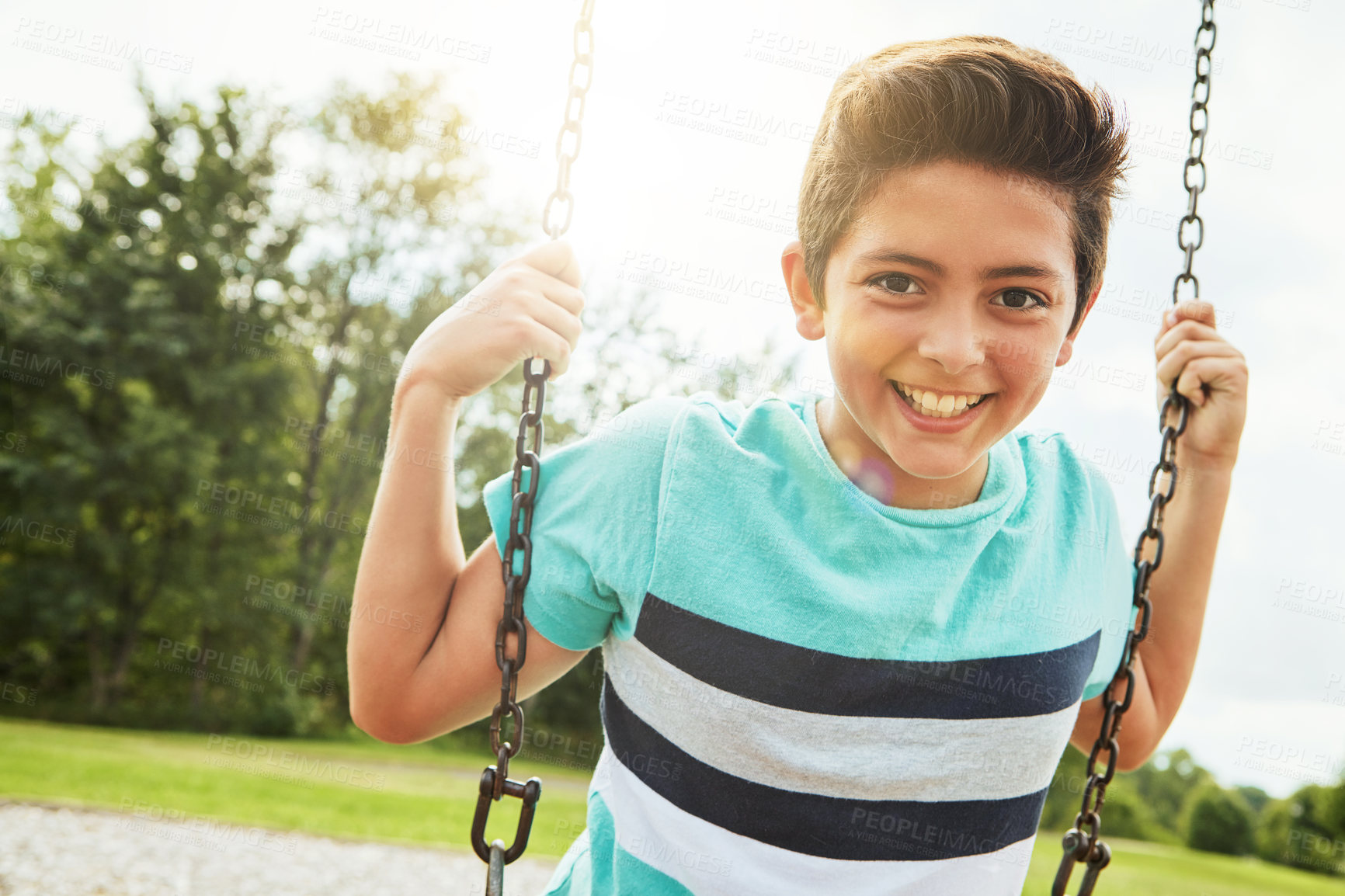 Buy stock photo Boy, portrait and smile with nature, swing and park for outdoor fun and play with fresh air. Child, tree and playground game with summer, freedom and holiday or break outside with happiness.