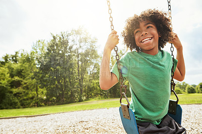 Buy stock photo Smile, nature and child on swing in park for fun, adventure and play time on holiday or weekend trip. Happy, cute and boy kid on motion equipment on playground in outdoor field on vacation in Brazil.