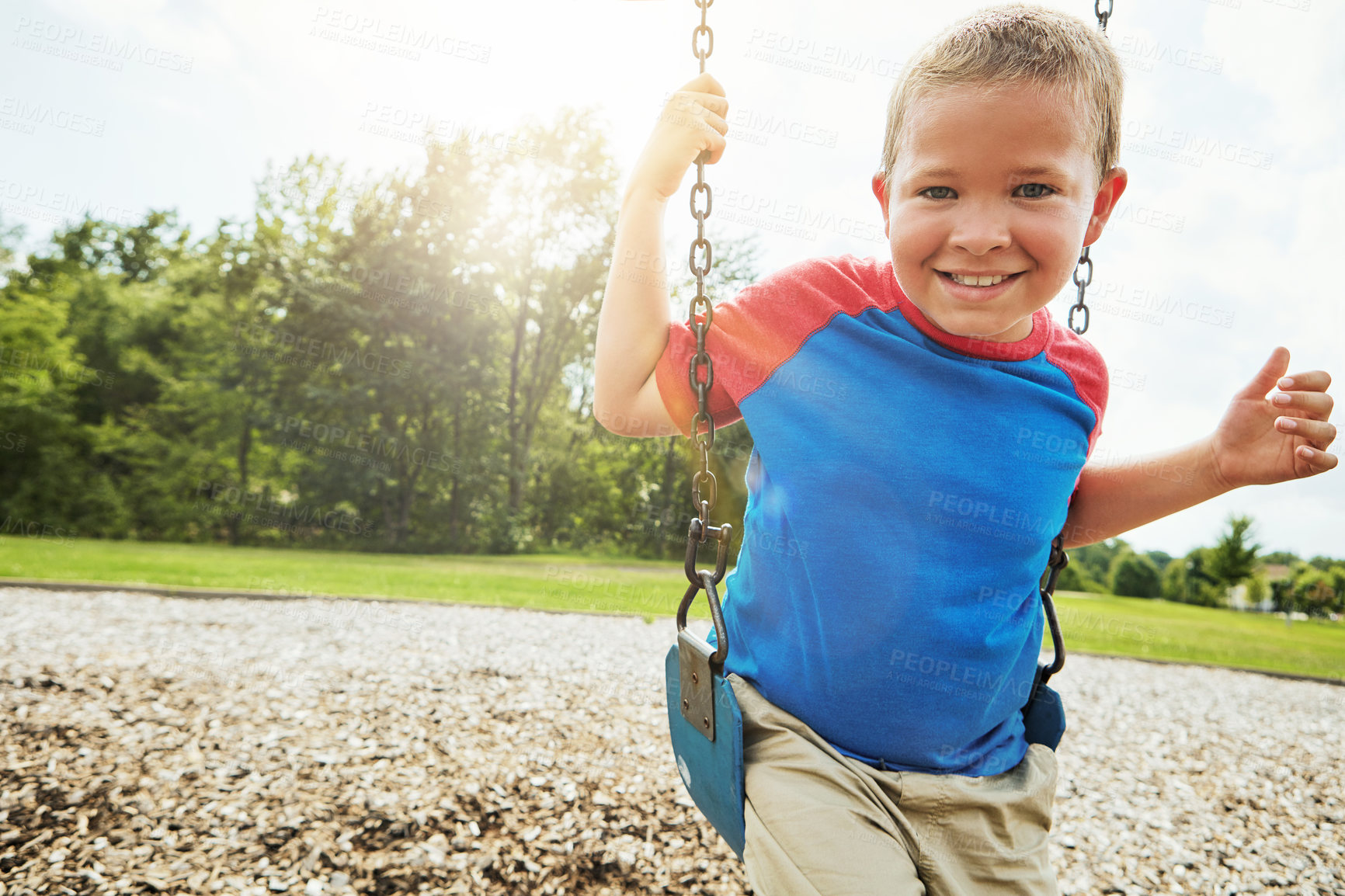 Buy stock photo Portrait, nature and child on swing in park for fun, adventure and play time on holiday or weekend trip. Happy, cute and boy kid on equipment on playground in outdoor field on vacation in Canada.