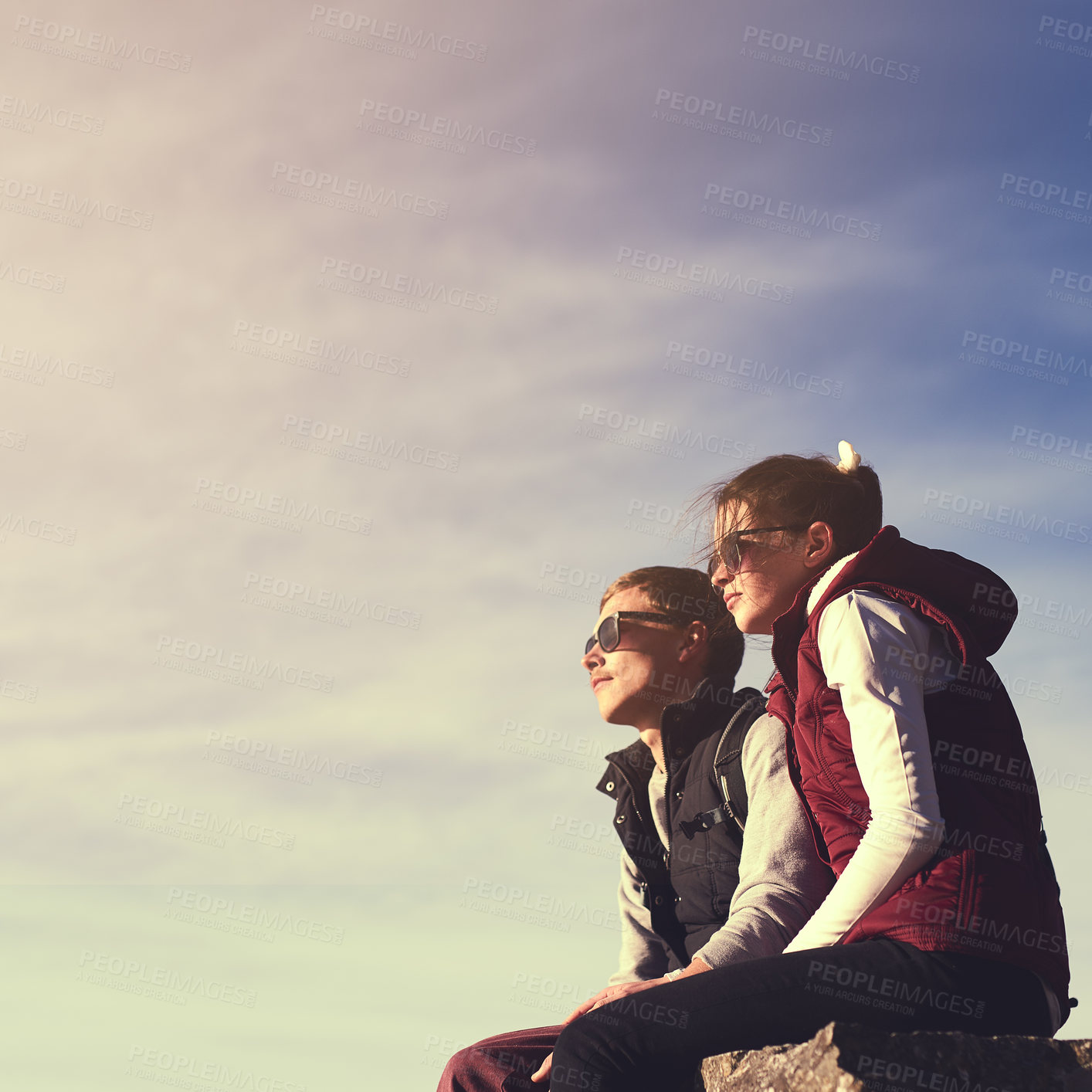 Buy stock photo Space, view and couple on mountain peak for travel, adventure or hiking journey in outdoor mockup. Sky, relax or people on rock together for holiday vacation, love or trekking to explore on cliff