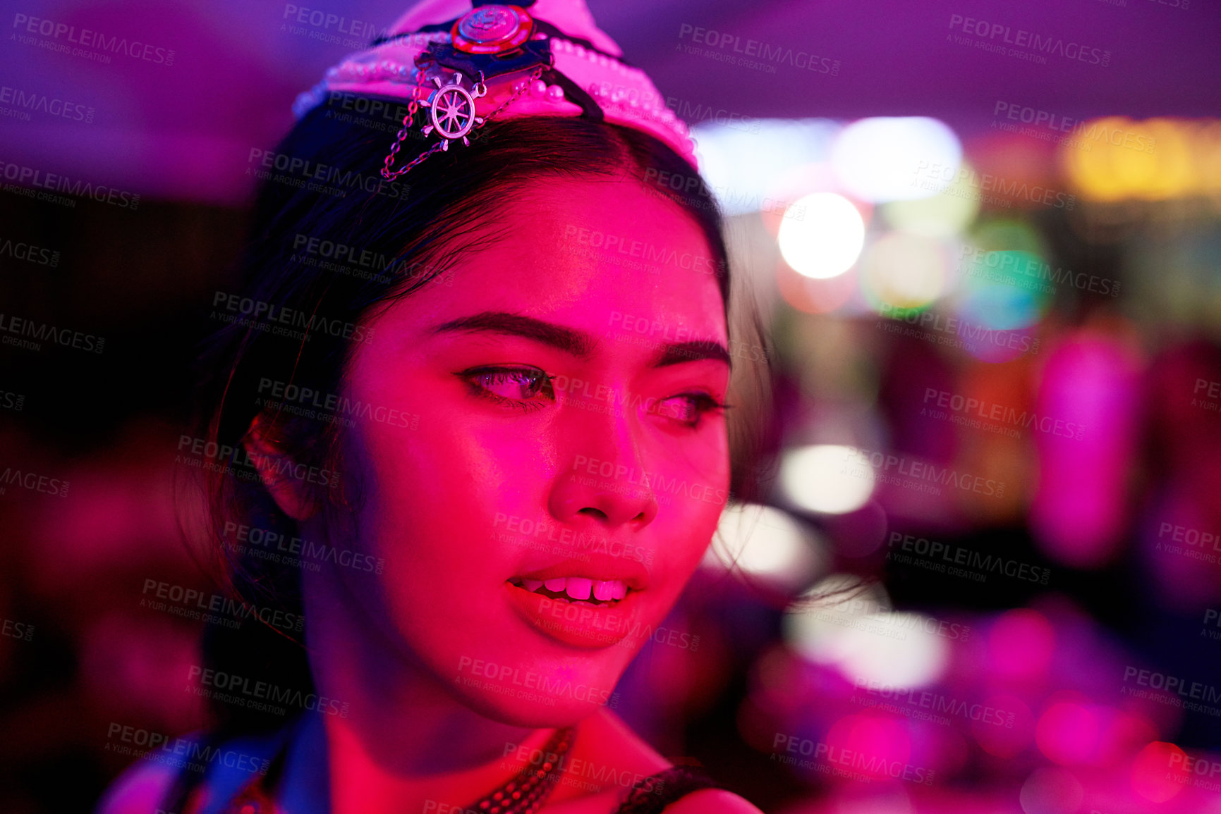 Buy stock photo Shot of a young woman working in a neon lit Thai nightclub