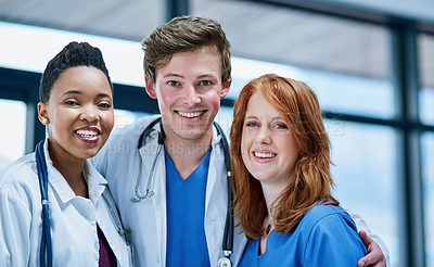 Buy stock photo Portrait of a team of confident young doctors working in a hospital