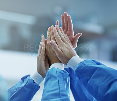 Buy stock photo Cropped shot of a team of surgeons giving each other a high five