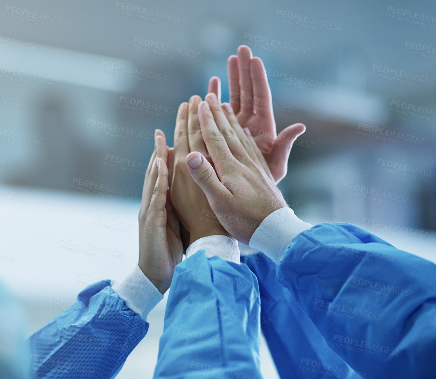 Buy stock photo Cropped shot of a team of surgeons giving each other a high five
