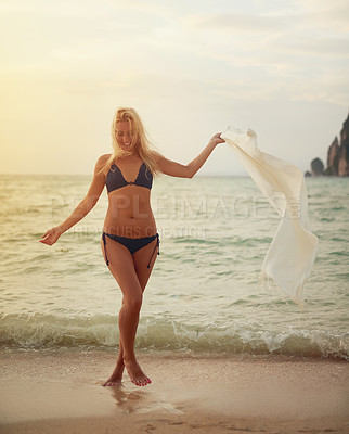 Buy stock photo Shot of a beautiful young woman in her bikini on the beach