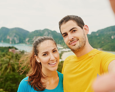 Buy stock photo Portrait of a happy young couple taking a selfie on an island vacation