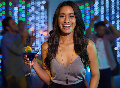 Buy stock photo Portrait of an attractive young woman having a drink while partying in a club