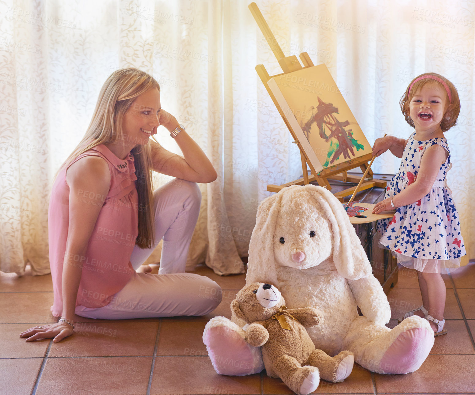 Buy stock photo Portrait of an adorable little girl painting a picture while her mother watches at home