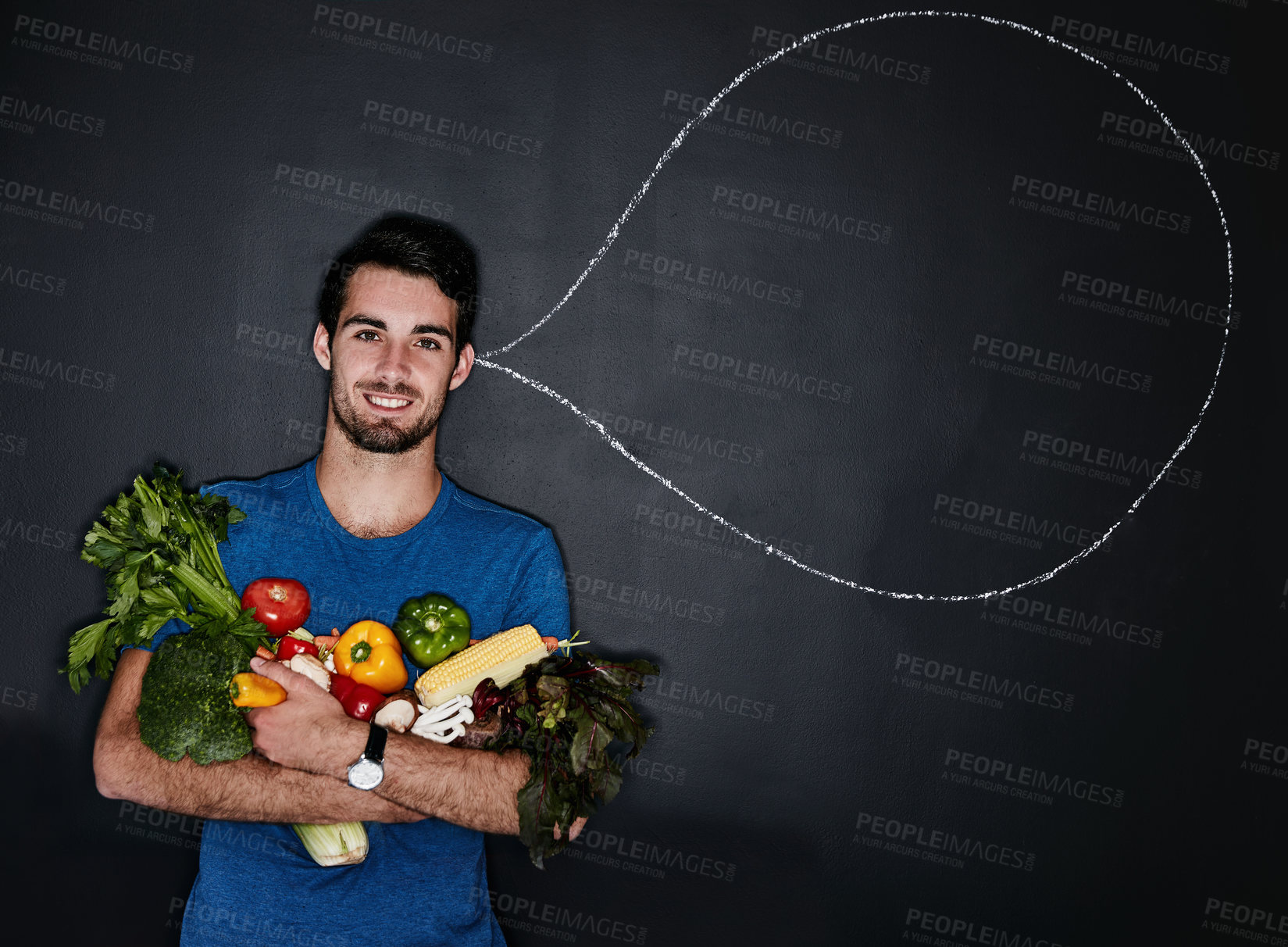 Buy stock photo Studio portrait of a young man carrying vegetables next to an illustration of a thought bubble against a dark background