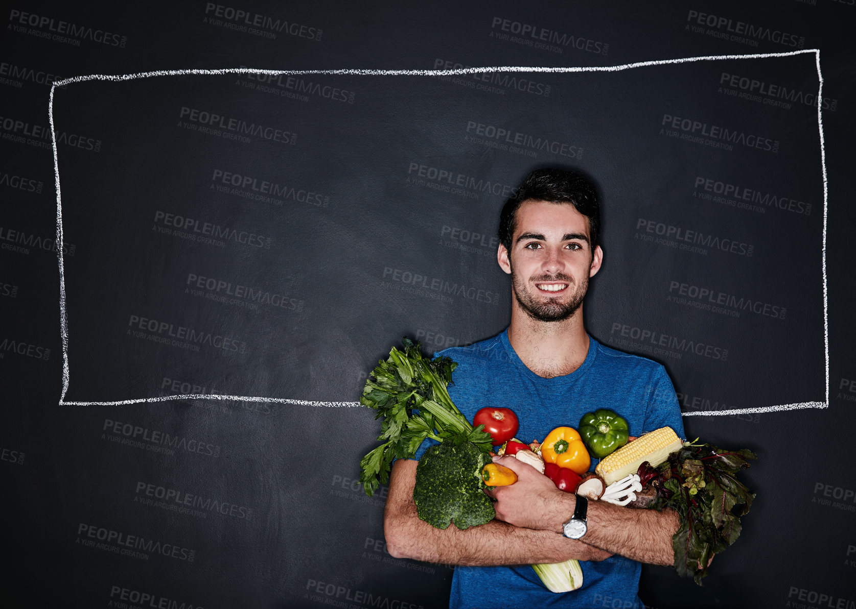 Buy stock photo Studio portrait of a young man carrying vegetables against a chalk illustration of a box on a dark background