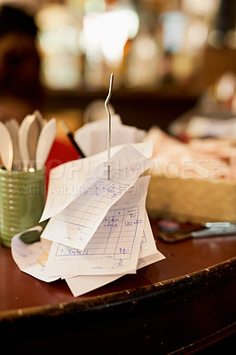 Buy stock photo Shot of slips on a receipt holder in a restaurant