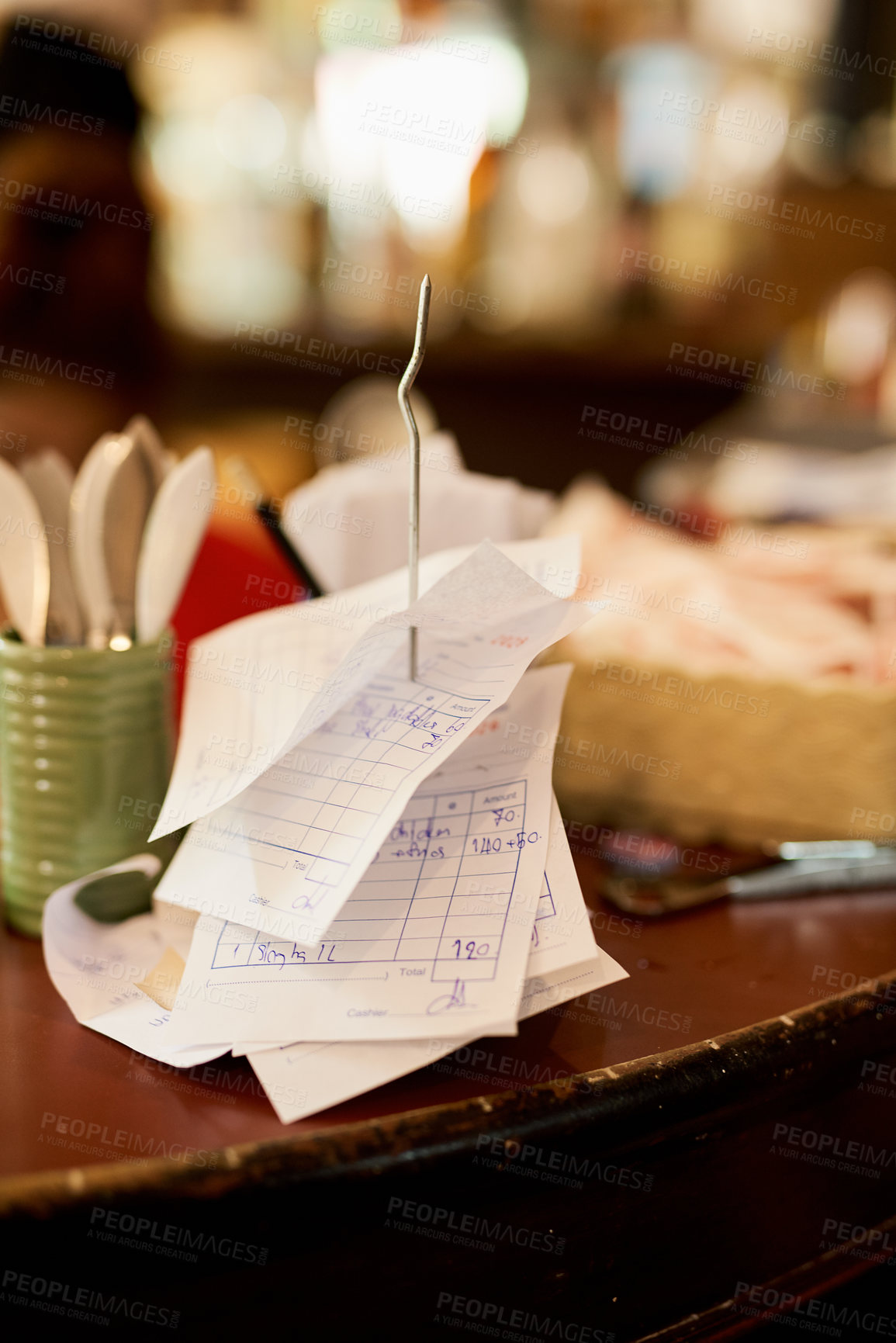 Buy stock photo Shot of slips on a receipt holder in a restaurant