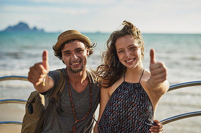 Buy stock photo Man, woman and beach holiday with thumbs up for wellness, joy for adventure travel in Europe. Happy couple, together and portrait with hand gesture by ocean for vacation, decision or vote result