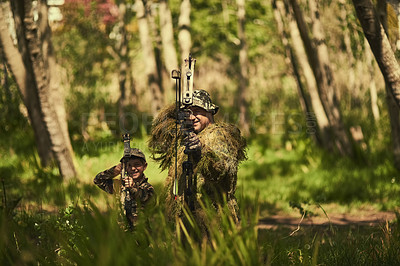 Buy stock photo Bow, camouflage or hunting with father and son in forest for getaway, leisure or weekend hobby. Family, training or trees and man on camping trip with boy child for bonding or recreation in woods