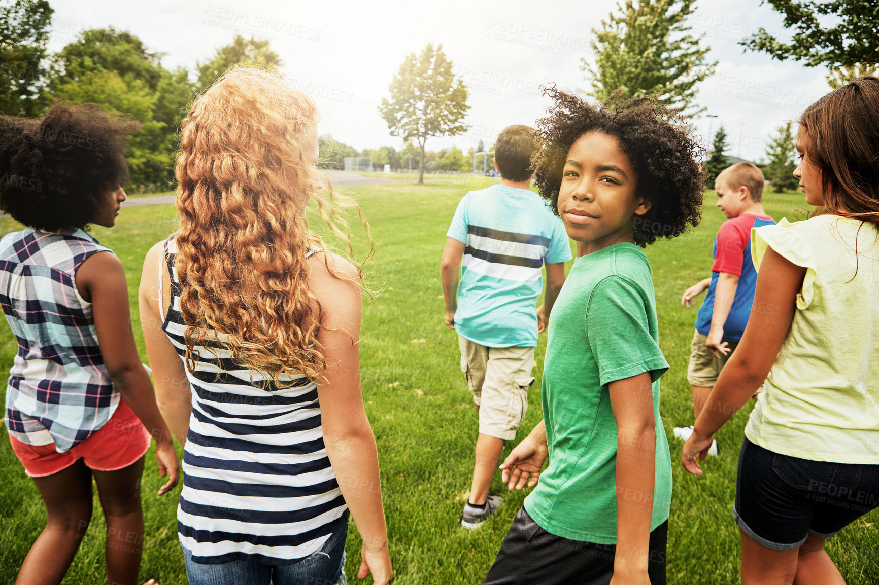 Buy stock photo Portrait of a young boy hanging out with his friends outside