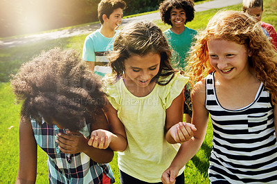 Buy stock photo Cropped shot of a group of diverse and happy kids hanging out together outside