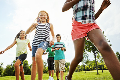 Buy stock photo Happy kids, diversity and running with youth in nature for fun, playful day or summer at park. Group of excited children or friends enjoying sunny outdoor holiday or weekend on grass field together